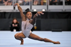 Simone Biles was adopted by her grandparents, who attempted to “soothe” her in competitions after being starved by her addict mother as a child,